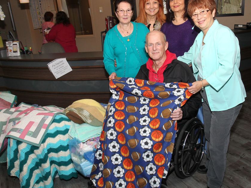 Volunteers donate handmade blankets to hospital patients
